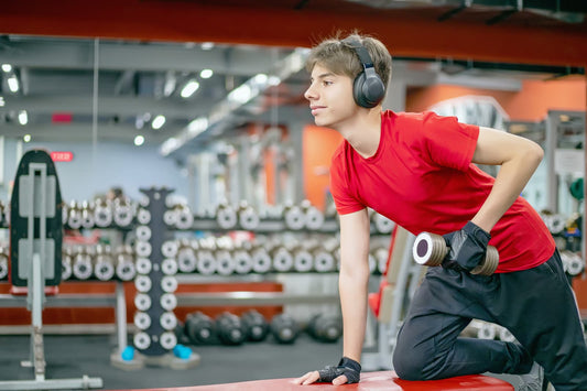 Adjustable dumbbell set - teenager is engaged in the gym