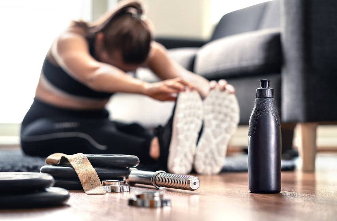 Home gym equipment - Woman stretching muscles before gym workout