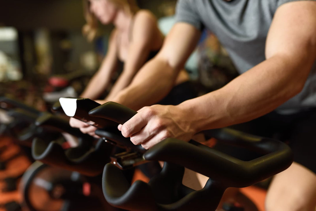 Weight lifting bench foldable - man biking in the gym exercising