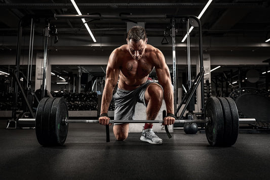 home gym equipment - man doing deadlift with a barbell