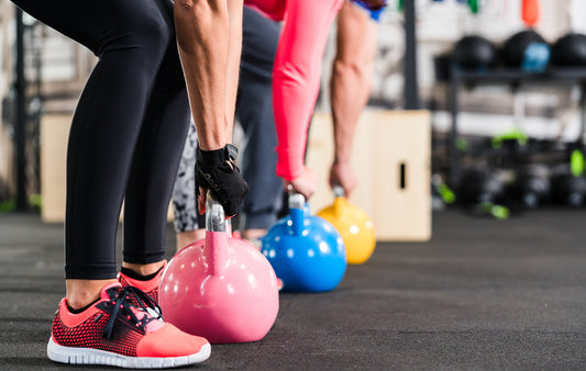 kettlebells - Group having functional fitness training with kettlebell