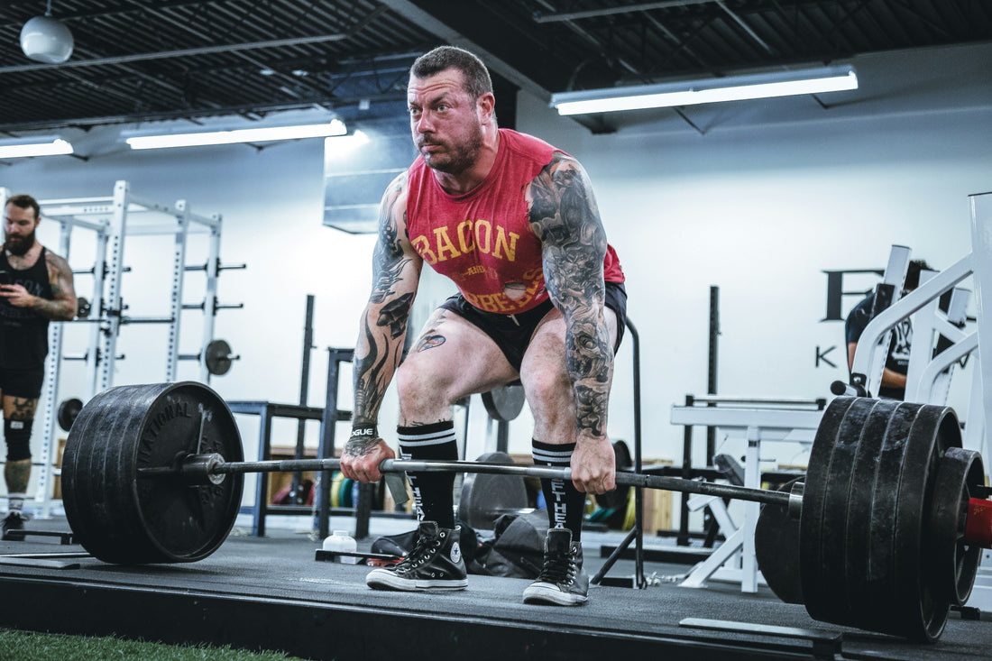 olympic bumper plates - man deadlifting