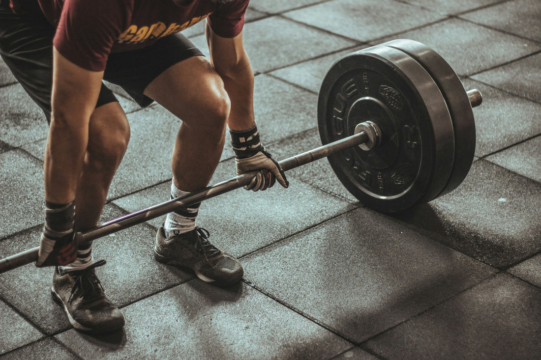 olympic weight plates - man deadlifting