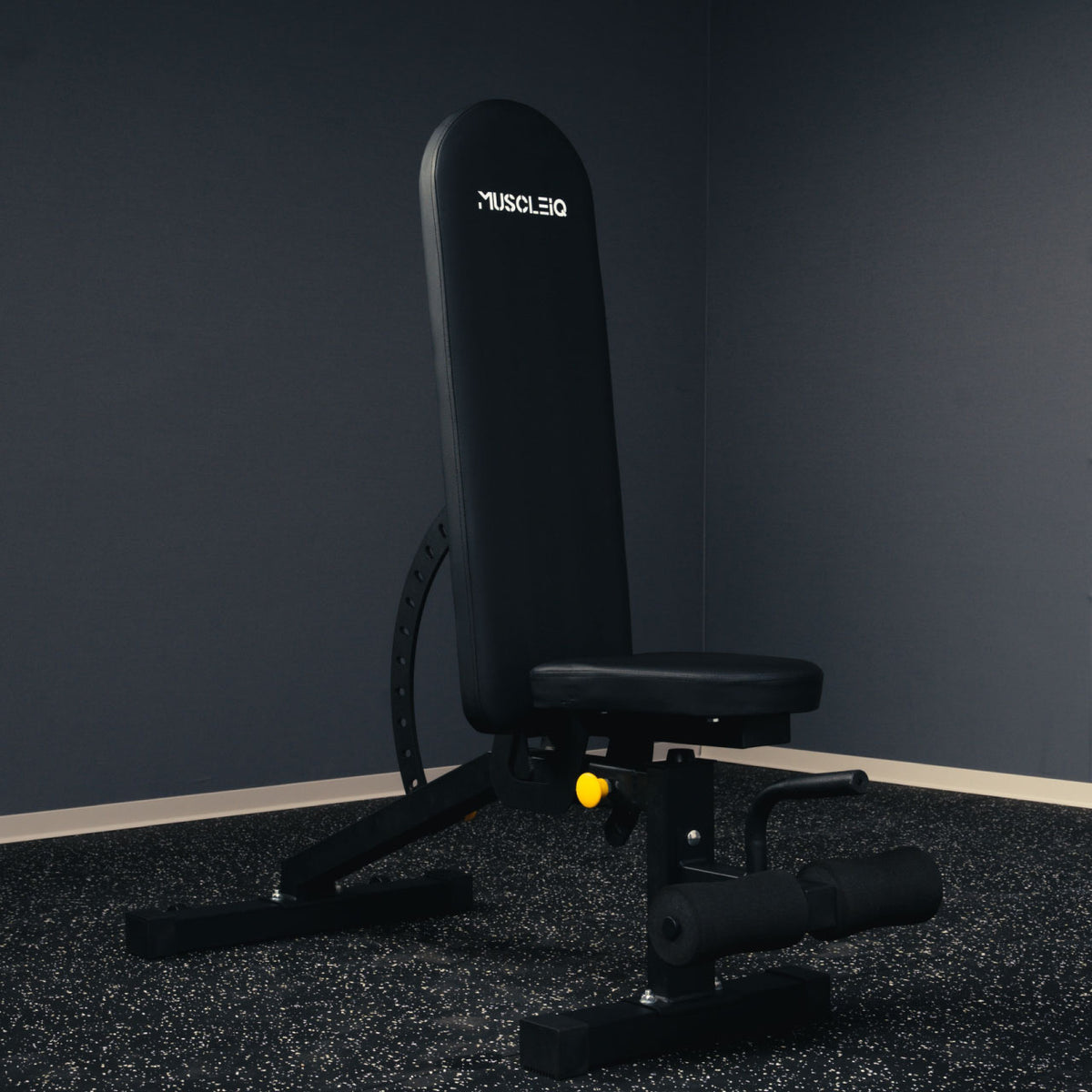 MUSCLEIQ adjustable weight bench with upright backrest on black rubber gym flooring