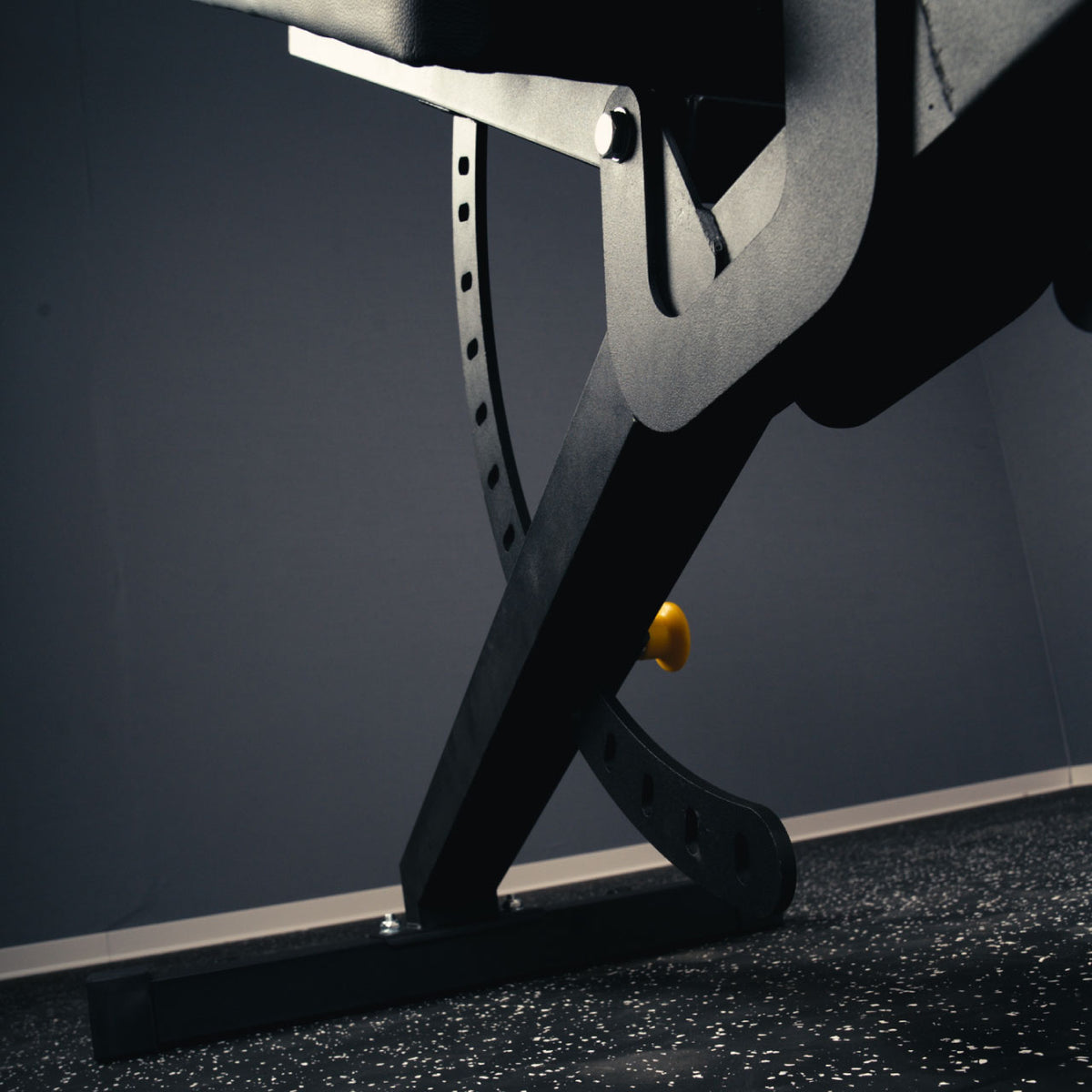 Close-up of the curved backrest adjustment rail and steel support frame on the MUSCLEIQ adjustable weight bench